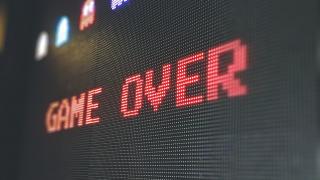 Retro video game font saying "Game Over" displayed on screen